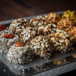 close-up-sweets-handmade-handmade-sweets-from-nuts-dried-fruits-honey-dark-wooden-table-horizontal