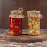 pickled-red-peppers-mushrooms-glass-jar-wooden-plate